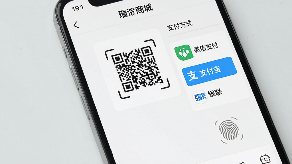 一幅展示智能手机支付界面的图片,屏幕中显示“瑞沣商城”的收银台页面,包含二维码扫描框、支付方式选择列表(微信支付、支付宝、银联)、指纹识别图标,背景为浅灰色,布局清晰,风格简洁,画质干净,无多余元素